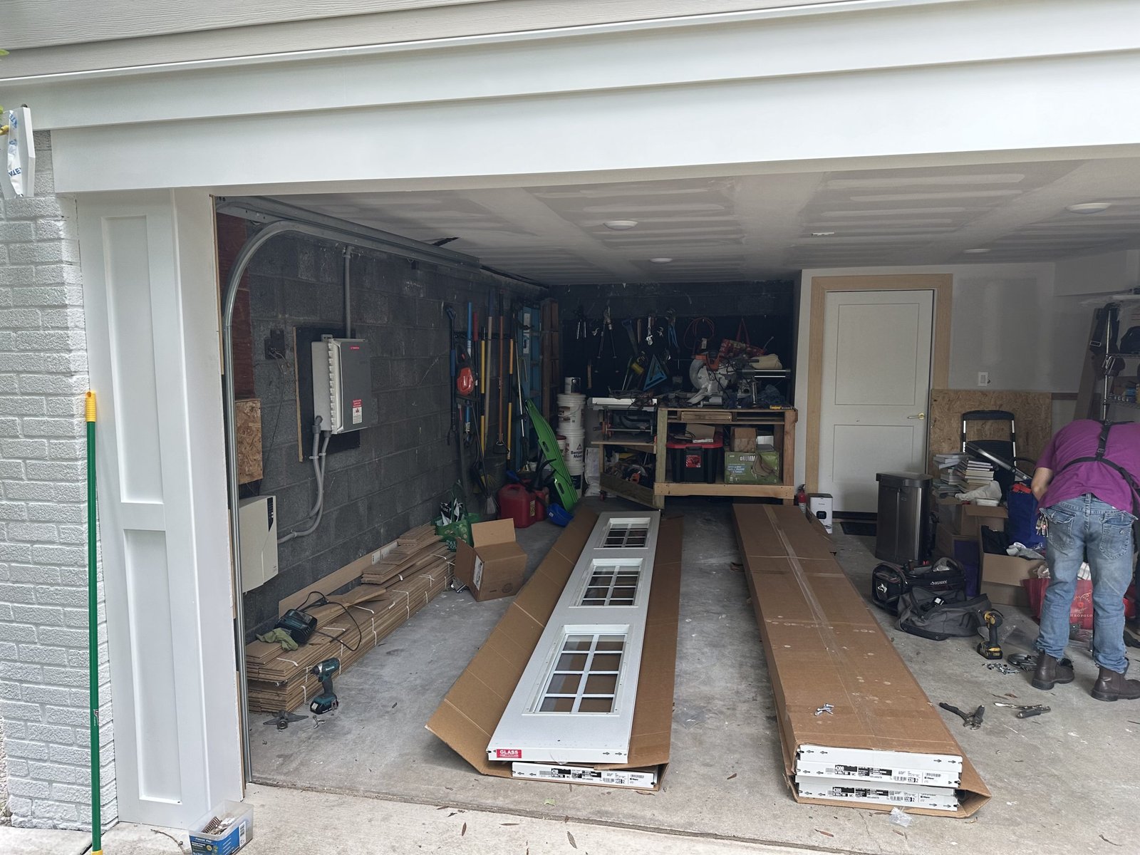 Damaged garage door panel being repaired by Parrish Garage Door Repair experts.